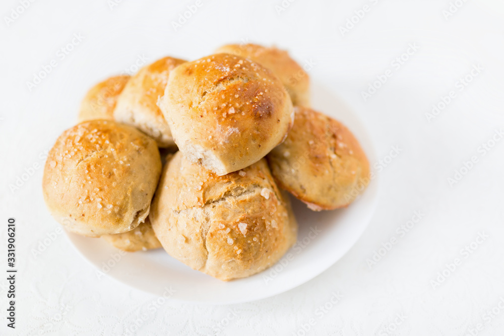 Fresh salty bread buns pastry topped with salt