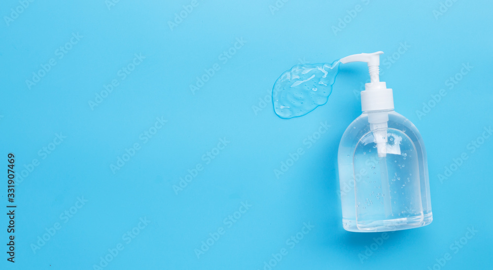 Alcohol hand sanitizer gel in pump bottles for hand hygiene corona virus (Covid-19) protection. Blue background - obrazy, fototapety, plakaty 