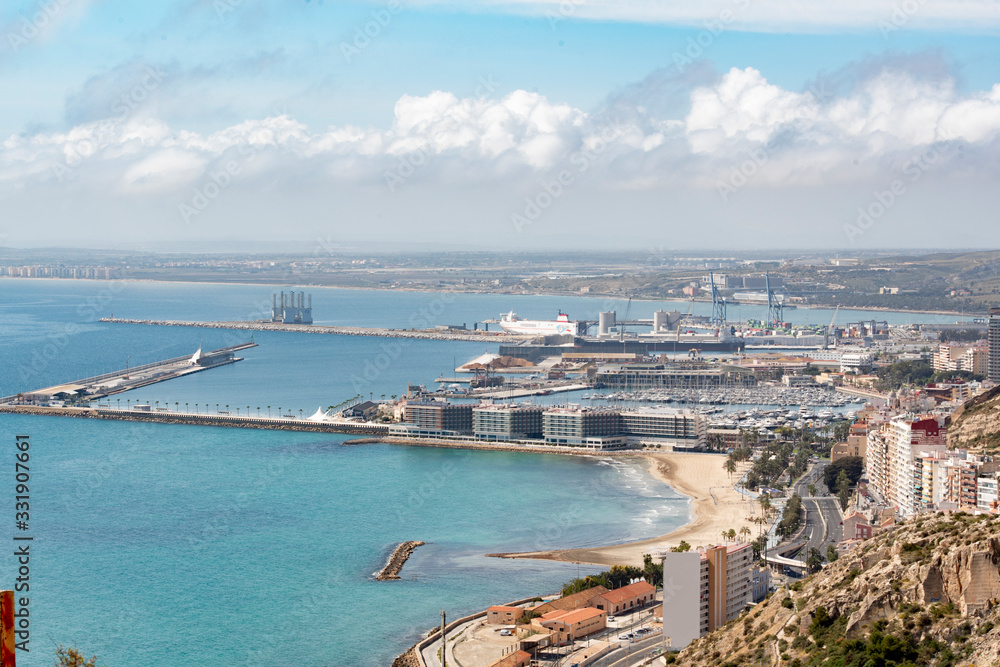 Panoramic view of Alicante, Valencian Community, Spain. In the foreground the Castle of Santa Barbara, the Postiguet beach and the port in the background with the city on its shore