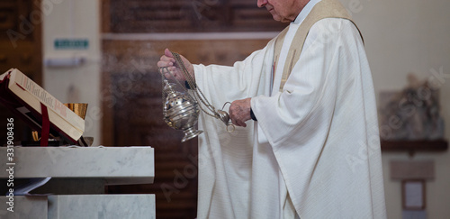 Fotografie, Obraz The priest of the Roman Catholic Church censers censer during the Holy Mass in the church