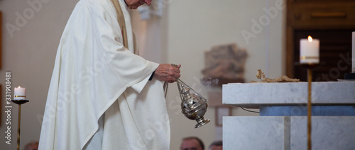 Konstfotografi The priest of the Roman Catholic Church censers censer during the Holy Mass in the church