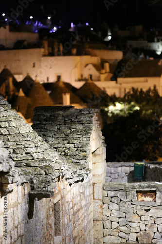 Obraz na płótnie Cityscape of Alberobello; the trulli UNESCO world heritage town with unique stone walls, coned roofs, whitewashed housed during sunset evening, . w salonie