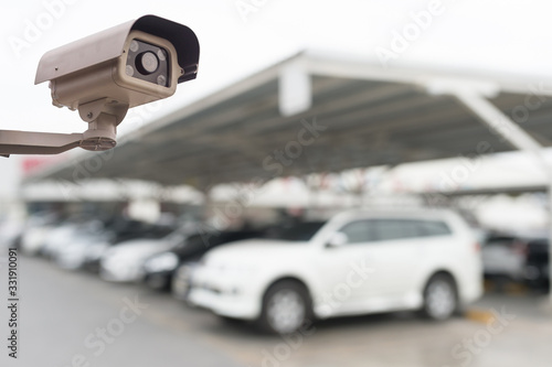CCTV security camera on blue car parking background