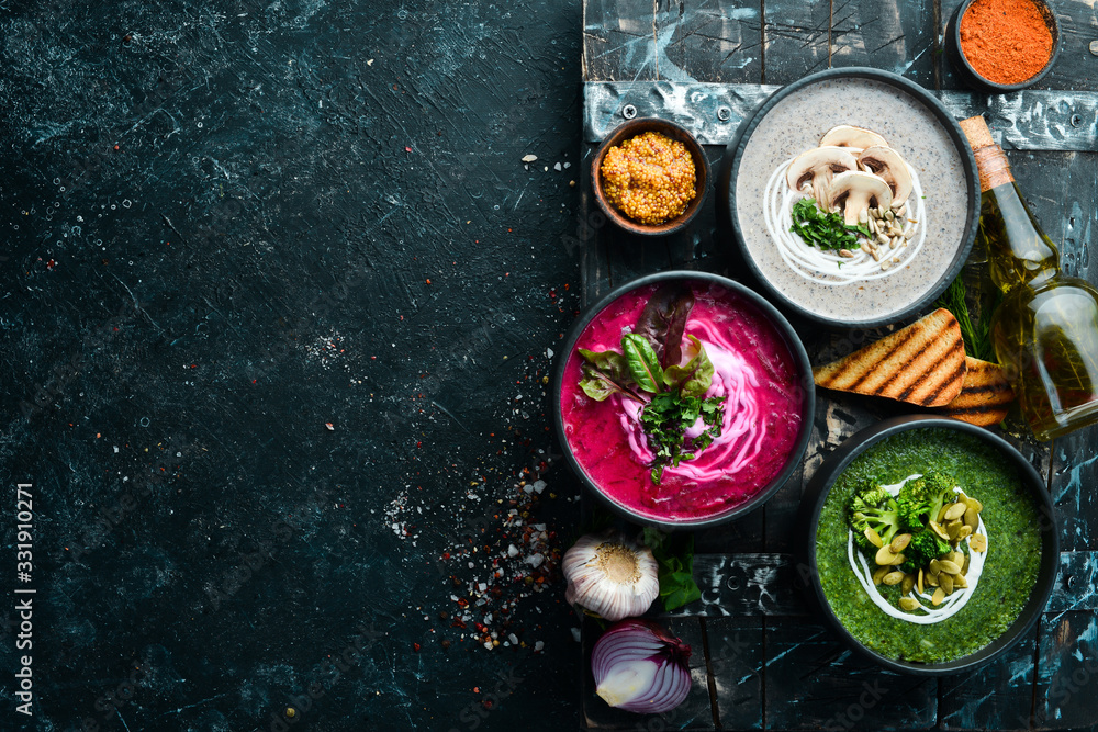 Three colored vegetarian soups. Mushroom, beetroot and broccoli soup. Top view. Three colored vegetarian soups. Mushroom, beetroot and broccoli soup. Top view.