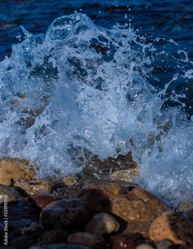splashing water on the seashore of the mallorca island, giving a moment of relaxation, tranquility and calmness 