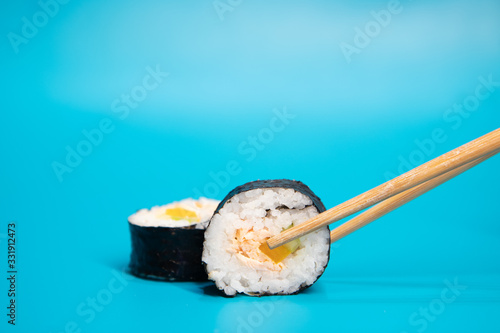 Japanese traditional Sake Maki sushi with salmon. Wooden chopsticks.