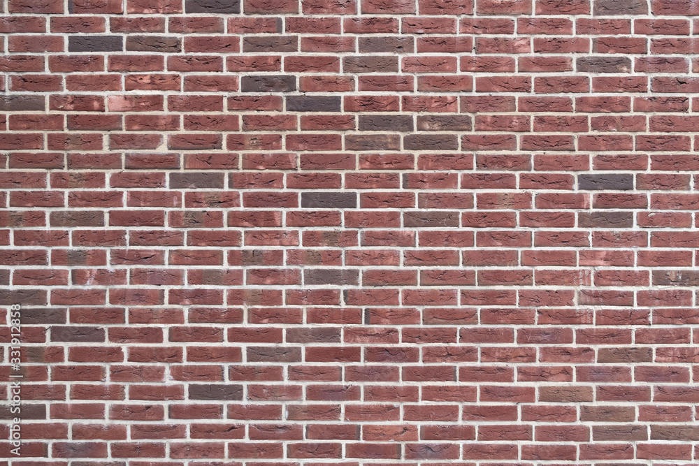 Fragment of the wall of an old building made of baked brick in natural light. Close-up. Texture. Background. Fragment of the wall of an old building made of baked brick in natural light. Close-up. Texture. Background.