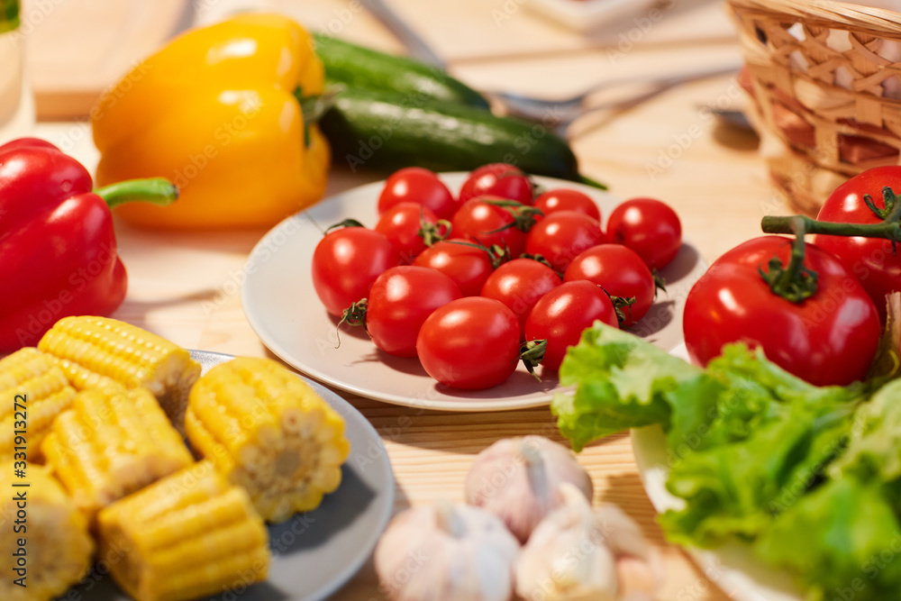 Close-up of fresh tomatoes corns and other vegetables on the table