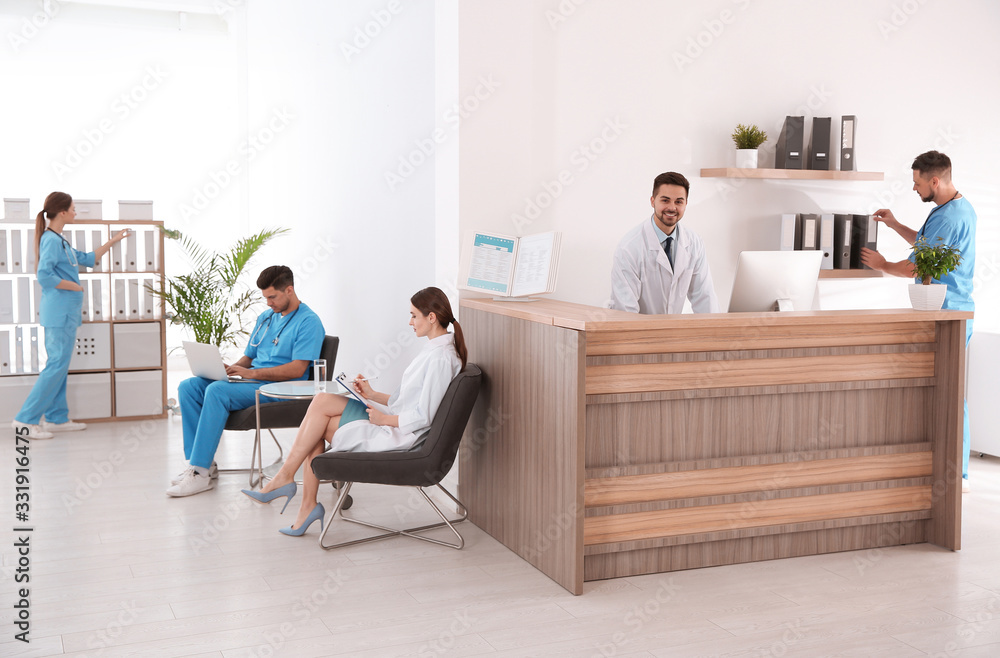 View of modern clinic with working doctors View of modern clinic with working doctors