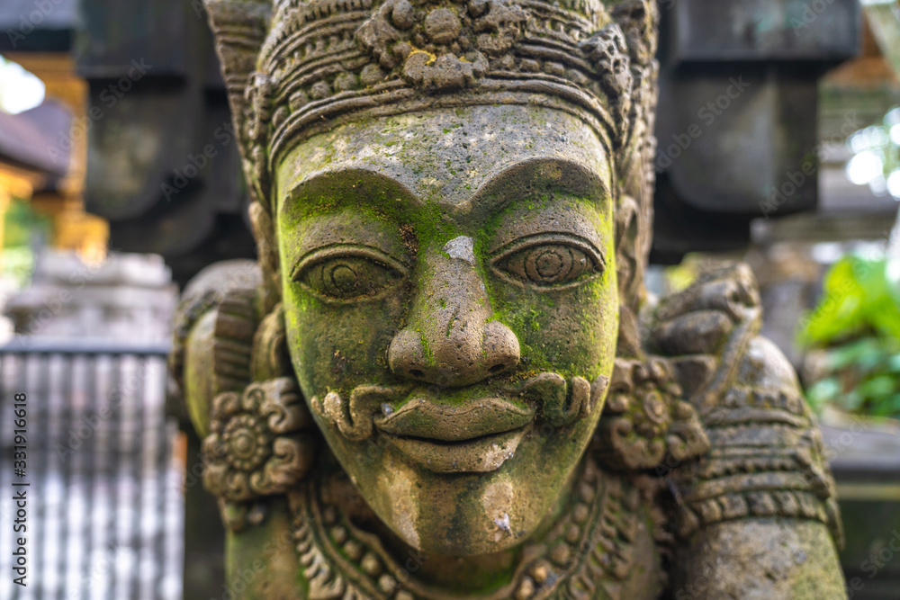 Close up of a balinese traditional statue of a mythological man in Tirta Empul Temple Close up of a balinese traditional statue of a mythological man in Tirta Empul Temple