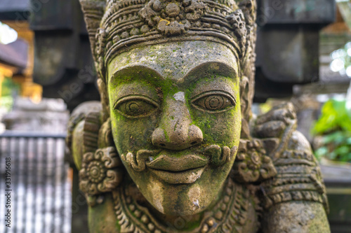 Close up of a balinese traditional statue of a mythological man in Tirta Empul Temple