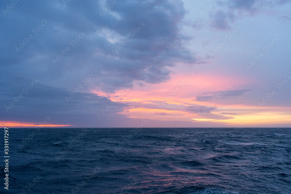 Colorful sunrise on the Drake Passage in the ocean