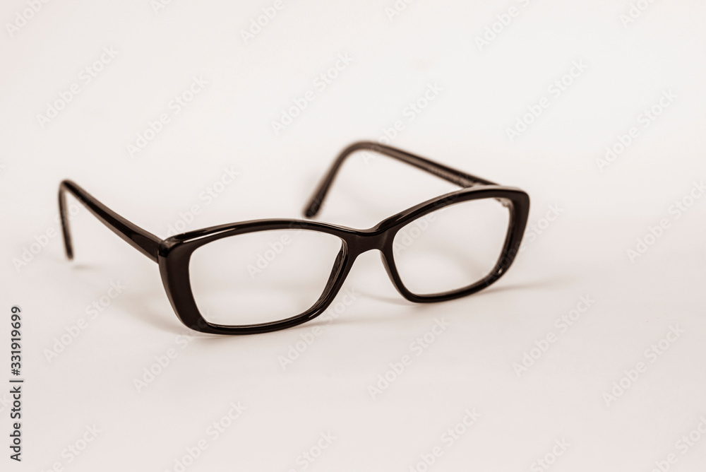 Goggles in black plastic frame on light background, medical ophthalmic concept Goggles in black plastic frame on light background, medical ophthalmic concept
