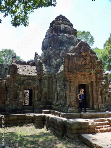 Ruins of Angkor, blond gril in temple door of Preah Khan, Angkor Wat, Cambodia