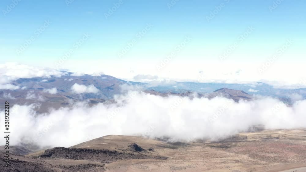 Aerial view showing a barren landscape with white clouds flowing over the landscape
Aerial view showing a barren landscape with white clouds flowing over the landscape