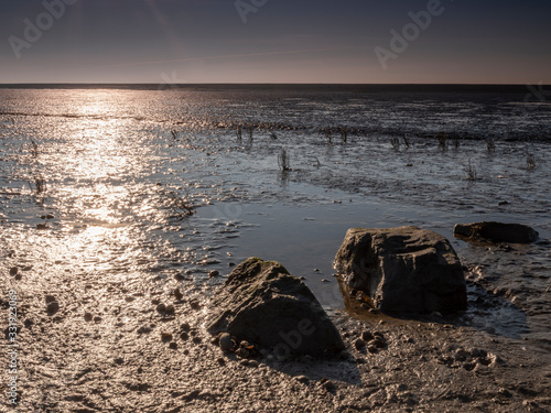 Aerial view of horizon over sea, with rocks in the foreground, national park and Unesco World heritage area Waddensea in Province of Friesland, Netherlands photo