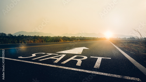 Concept of start straight and beginning for cooperation.Start text on the highway road concept for planning and challenge or career path,business strategy,opportunity and change in sunset background. photo