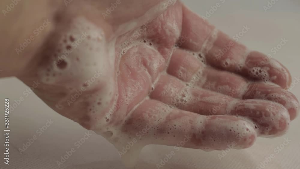 Hands squeeze soapy water suds macro shot Hands squeeze soapy water suds macro shot