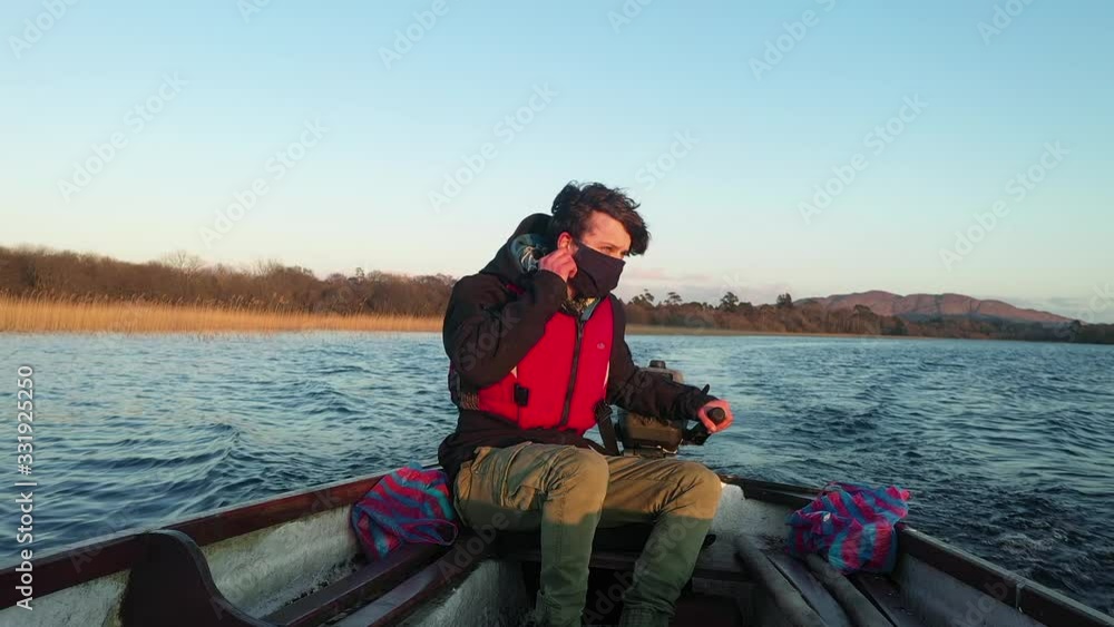 Young man boat removing mask fleeing Corona virus pandemic wilderness 4K Young man boat removing mask fleeing Corona virus pandemic wilderness 4K