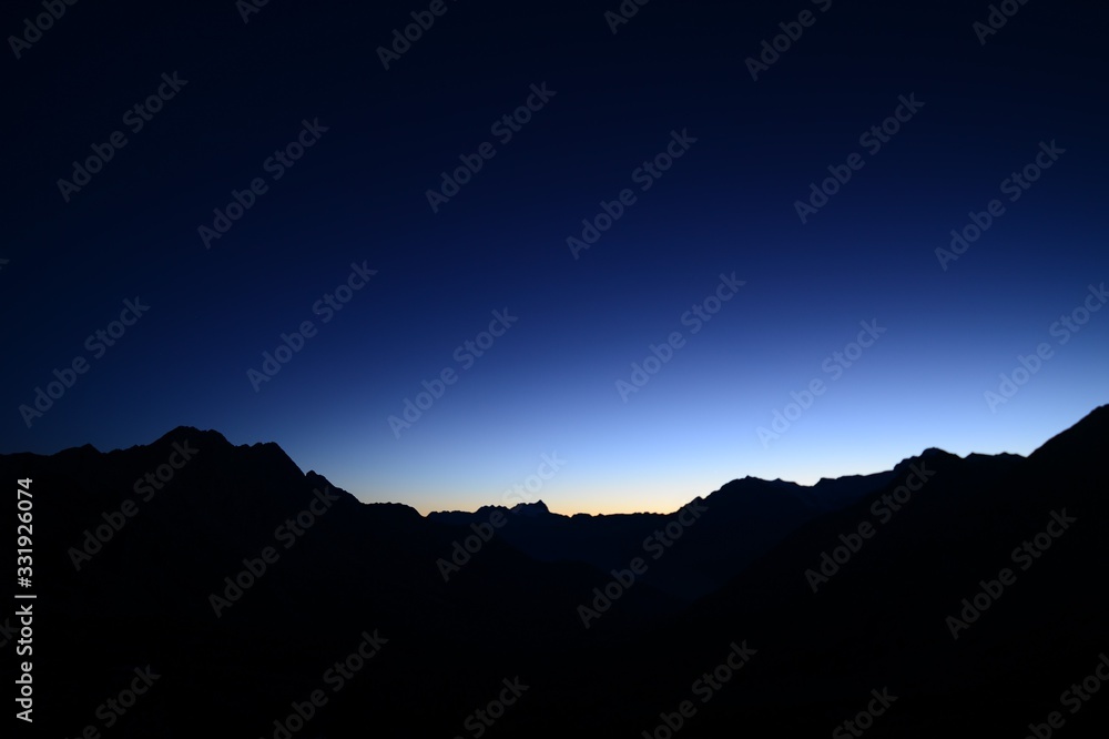 Silhouette of mountains in the Swiss mountain landscape at sunrise Silhouette of mountains in the Swiss mountain landscape at sunrise