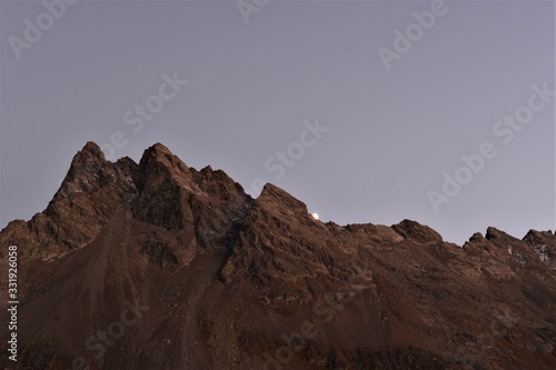 Silhouette of mountains in the Swiss mountain landscape with the moon rising © Ben T.