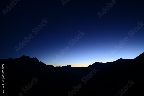 Silhouette of mountains in the Swiss mountain landscape at sunrise