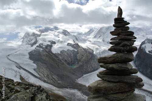 cairn in the Swiss Alps with glaciers in the background © Ben T.