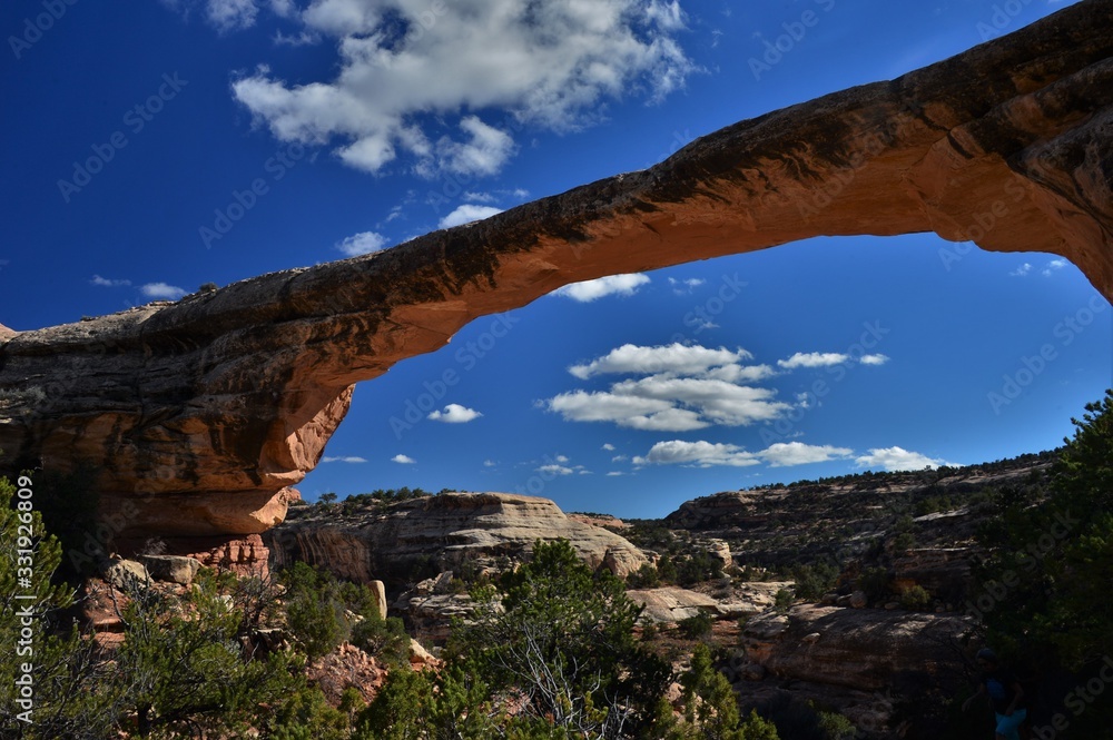 natural stone bridge in the usa against a blue sky with white clouds