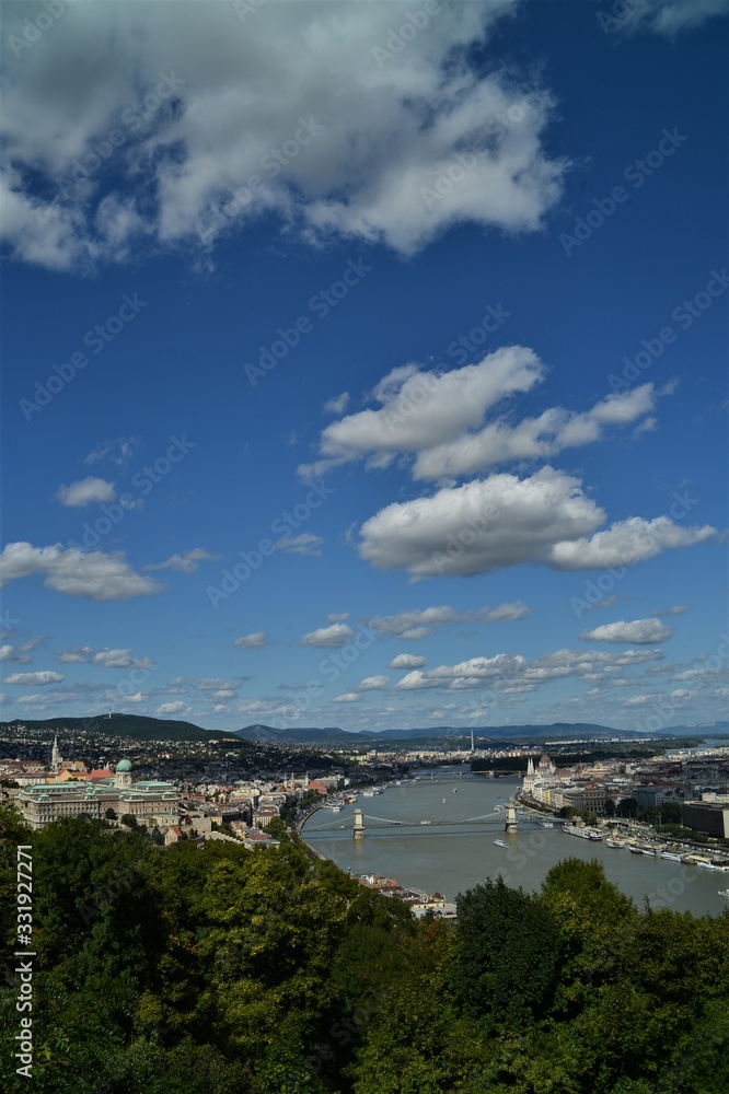 Budapest with the Danube seen from above on a summer day with a blue sky and white clouds
