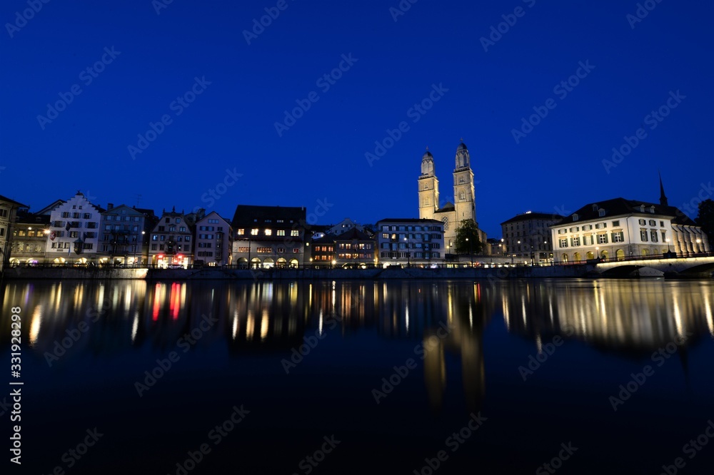 the old town of zurich switzerland on the limmat river at night with the grossmünster
