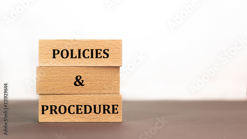 policies and procedure word written on wood block on white background. Time to say text on wooden table for your desing, concept.