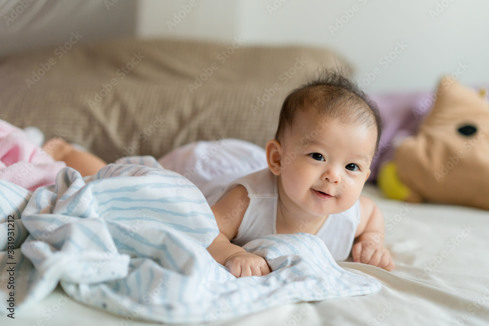 Asian baby in bed close up.