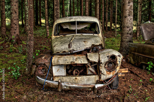 abandoned old rusty volvo pv444 car in the forest