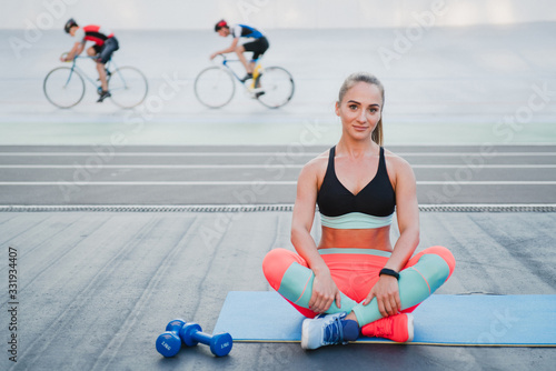 Sports and fitness outside the gym. Young fit woman with perfect body in sportswear trains outdoors on the playground. Sportive and healthy lifestyle, street work out, training, exercise concept.