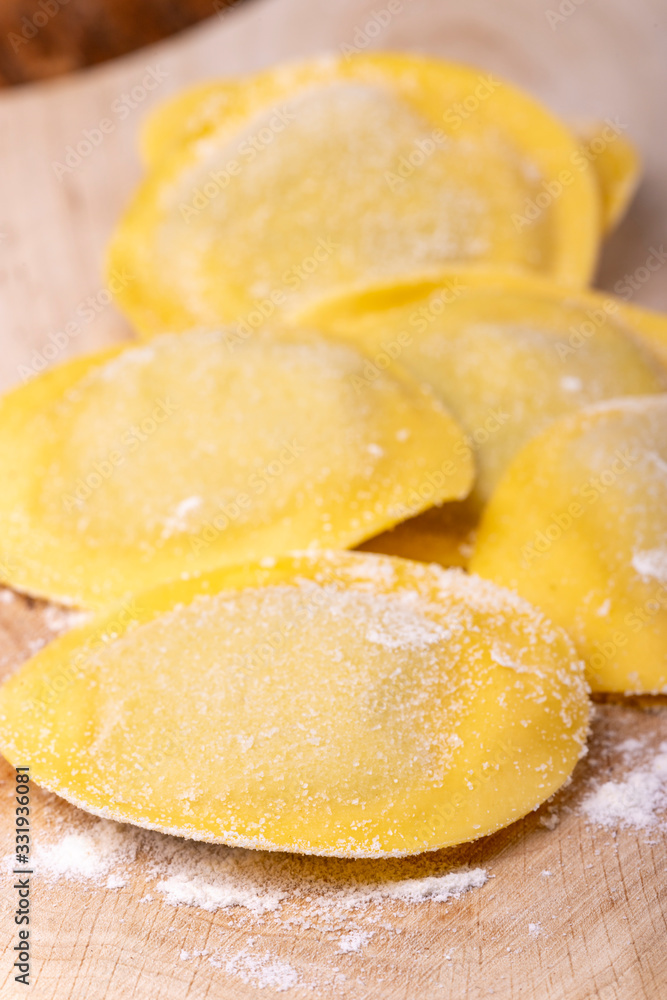 raw italian tortelli pasta with flour