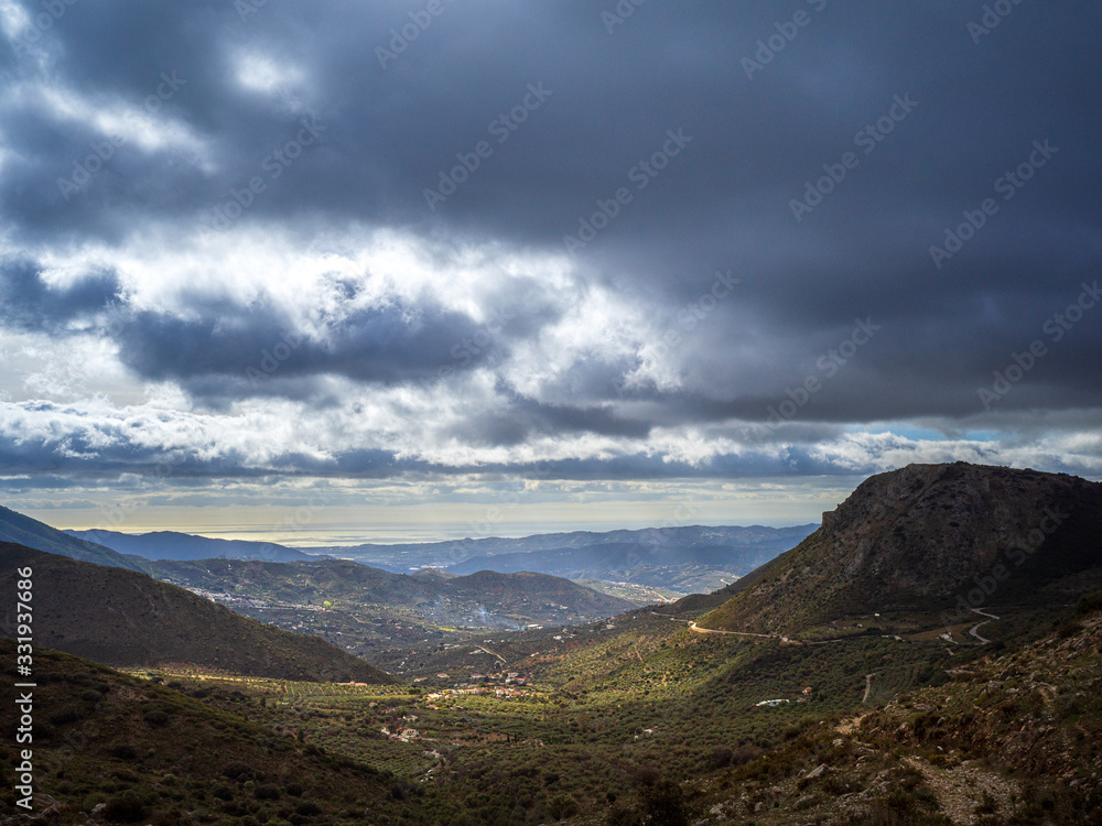 Dramatic landscape of mountains and valley and cloudy sky