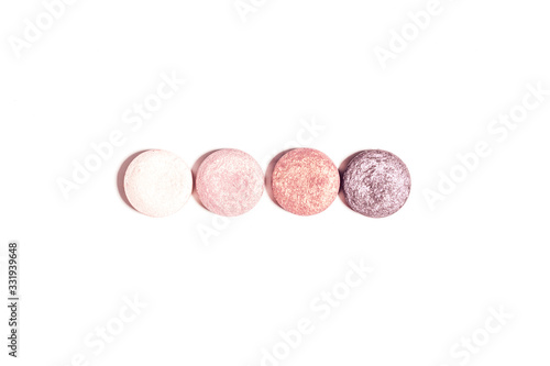 Flat lay with make up products in minimal style on white desk. Close up of spring eyeshadow palette in pink and purple colors. Top view, copy space.