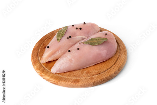 Raw chicken fillets on wooden board isolated on white background.