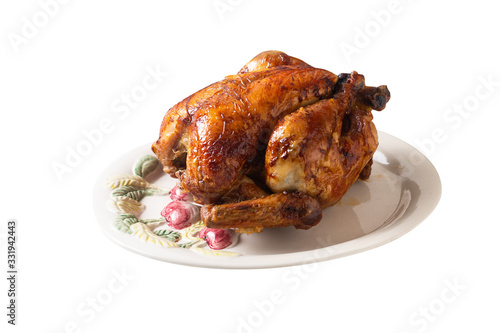 Food concept Roasted, Grilled Whole organic chicken on white ceramic plate isolated on with background with clipping path