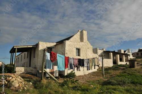 old fisherman's cottage with brightly colored washing on a line