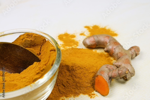 Turmeric powder and fresh turmeric roots isolated on a white background are ingredients in turmeric foods and ingredients in skin care products. Turmeric helps the skin to be strong.