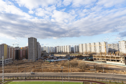 view from a height of a residential quarter of a metropolis with a construction site