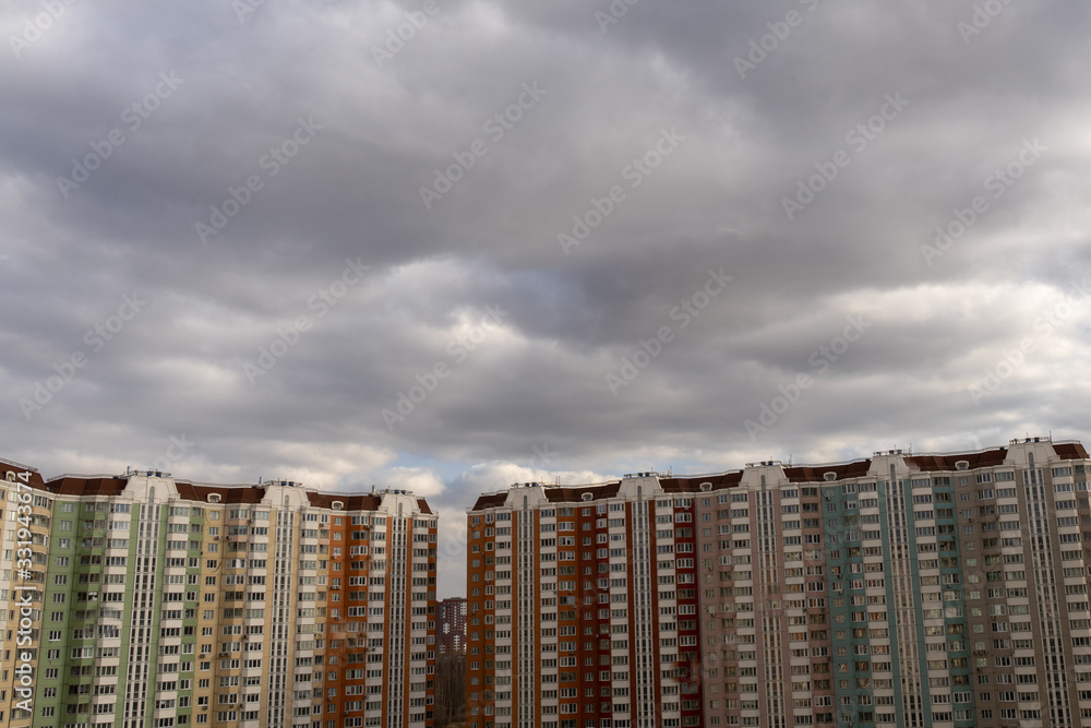 roofs of multi-storey buildings and beautiful sky with clouds