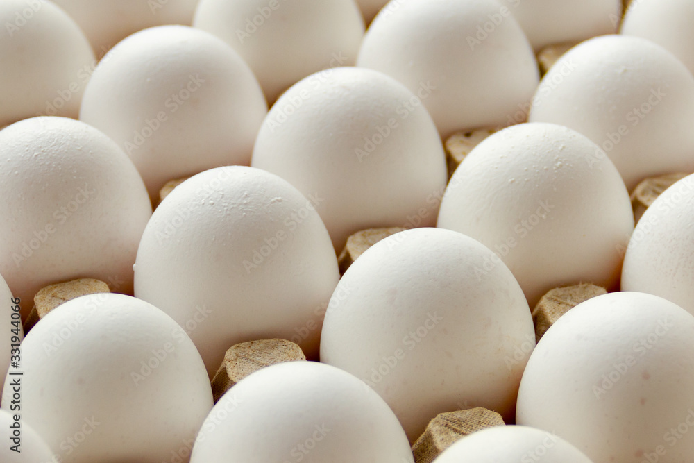 Chicken eggs in the cell egg tray. Top view, background Chicken eggs in the cell egg tray. Top view, background
