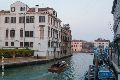 Wallpaper Mural Twilight in Venice, Italy. View of the Grand Canal and houses on the shore, people ride boats. Torontodigital.ca