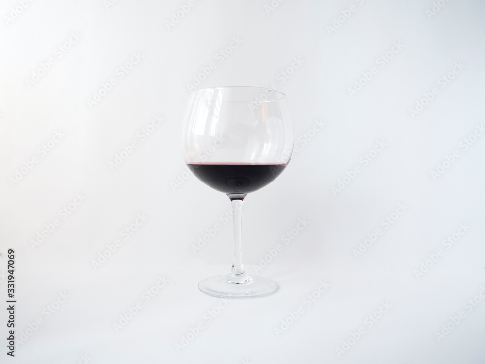 Red wine in a glass on white background Red wine in a glass on white background