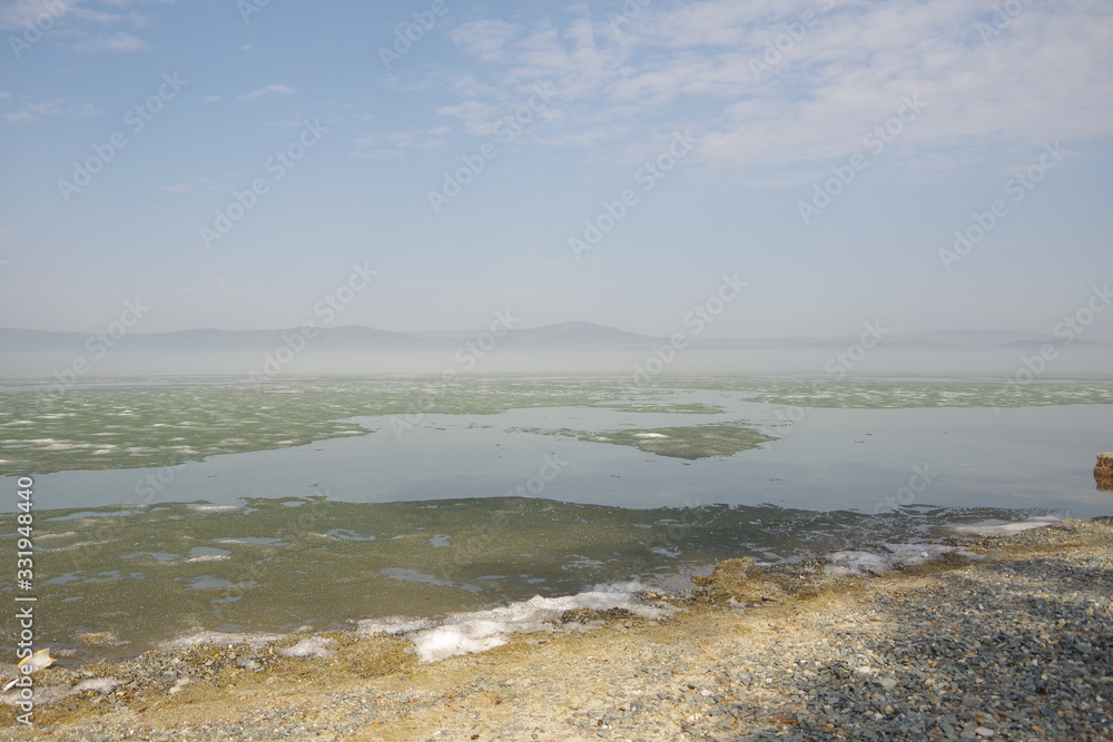 Morning fog on the lake, sunrise, lake in ice, ice is melting on the lake Morning fog on the lake, sunrise, lake in ice, ice is melting on the lake