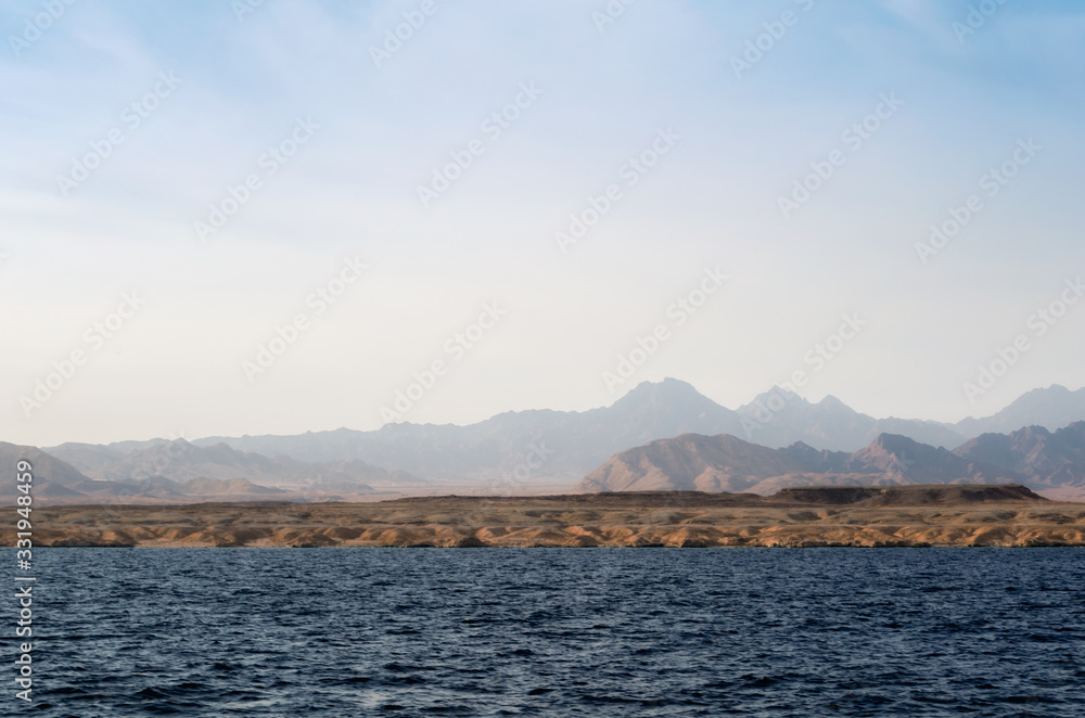 rocky coast of the Red Sea and.blue sky with clouds