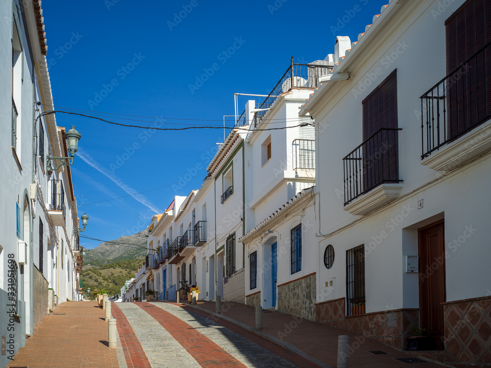 Narrow street in small Spanish town in Nerja, Costa del Sol, Spain