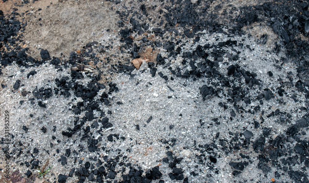 Fireplace ashes are a useful commodity for soil amendment or tossing on ice to prevent falls or repelling slugs. The gardens will benefeit from a covering of ashes. Bokeh effect. Fireplace ashes are a useful commodity for soil amendment or tossing on ice to prevent falls or repelling slugs. The gardens will benefeit from a covering of ashes. Bokeh effect.